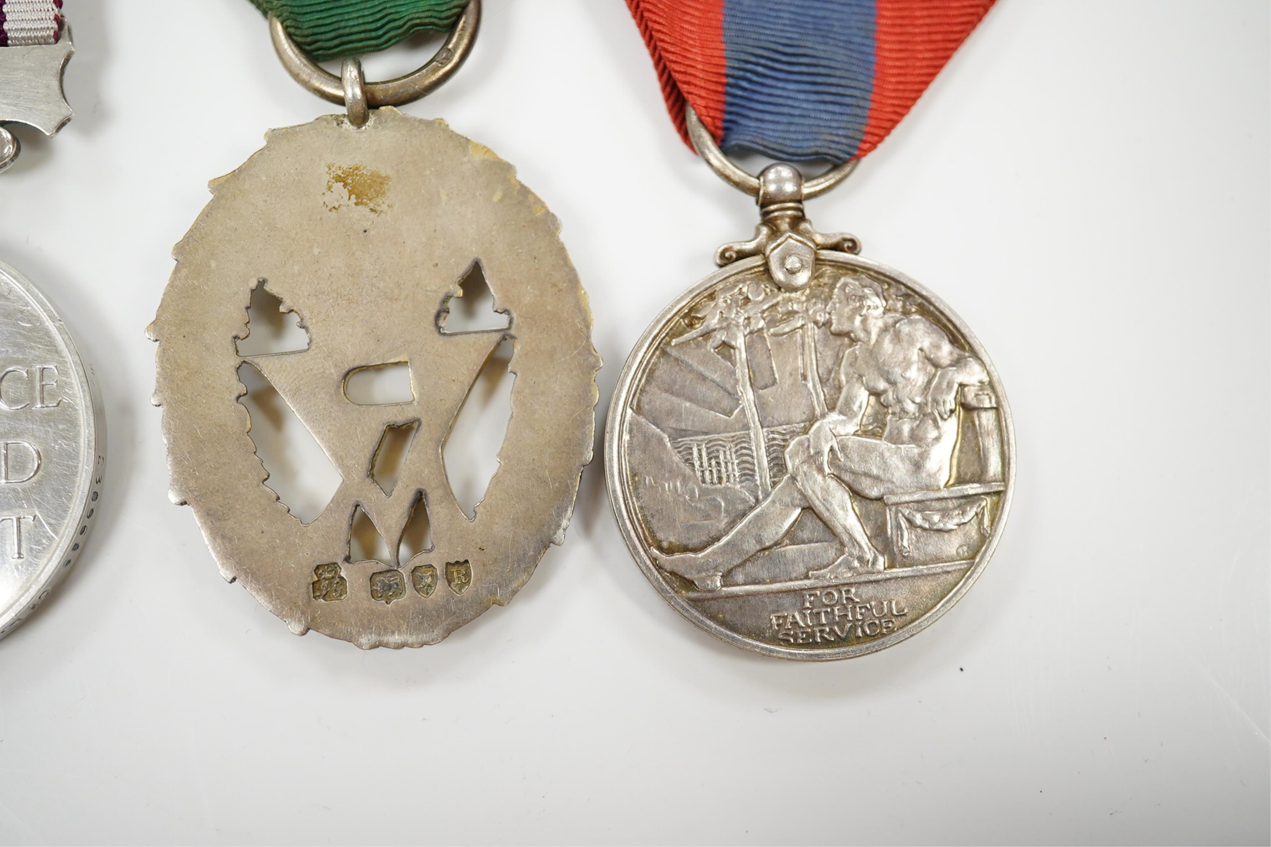 Four assorted service medals; Volunteer Officer's Decoration, hallmarked for 1892; EdVII Volunteer Long Service Medal to 3648 Pte W.Austin I/V B:Lanc:Fus; GV Imperial Service Medal to Frederick Allan Heselwood & Gv Regul